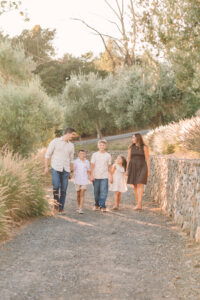 Sonoma Family Photographer captures family walking among olive trees at a private estate