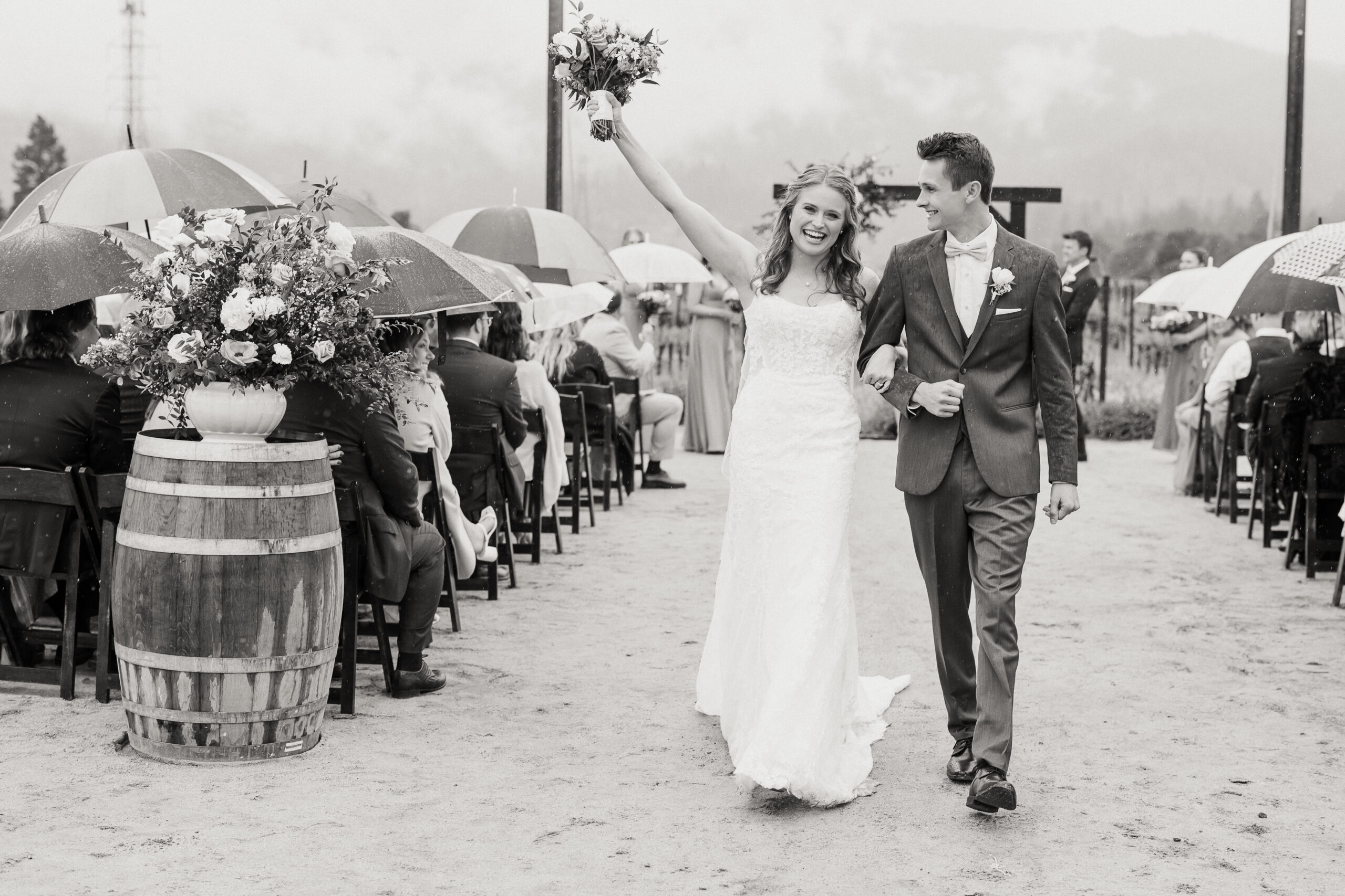 Bride and groom under clear umbrella during their rainy Brindare Napa Valley wedding, photographed by Napa Valley wedding photographer Courtney Stockton.